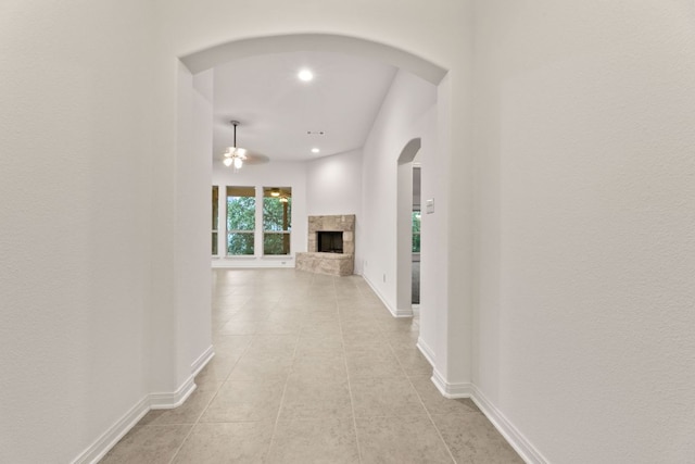 851 Stone Mountain Dr, Marble Falls, TX 78654 - hall featuring arched walkways, light tile patterned floors, and recessed lighting