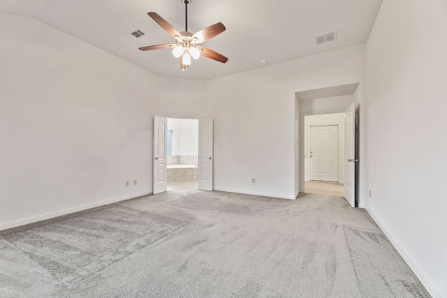851 Stone Mountain Dr, Marble Falls, TX 78654 - unfurnished bedroom with light colored carpet, connected bathroom, and a ceiling fan