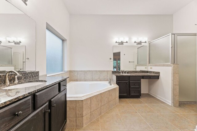 851 Stone Mountain Dr, Marble Falls, TX 78654 - bathroom featuring a garden tub, two vanities, a walk in shower, and tile patterned flooring