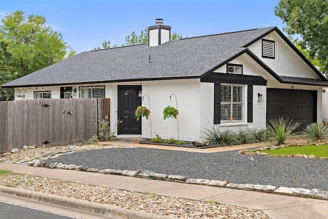 701 Mankato Dr, Austin, TX 78748 - view of front of property featuring roof with shingles, an attached garage, and a chimney
