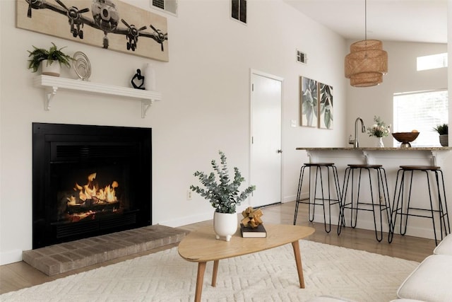 701 Mankato Dr, Austin, TX 78748 - living room with a brick fireplace, a towering ceiling, and wood finished floors