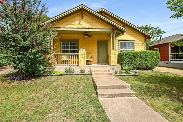 7312 Meador Ave, Austin, TX 78752 - view of front of house featuring a ceiling fan, a porch, and a front lawn