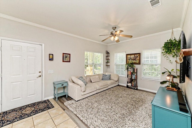 7312 Meador Ave, Austin, TX 78752 - tiled living room featuring ceiling fan and ornamental molding