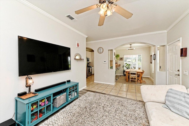 7312 Meador Ave, Austin, TX 78752 - living area with ceiling fan, arched walkways, crown molding, and tile patterned flooring