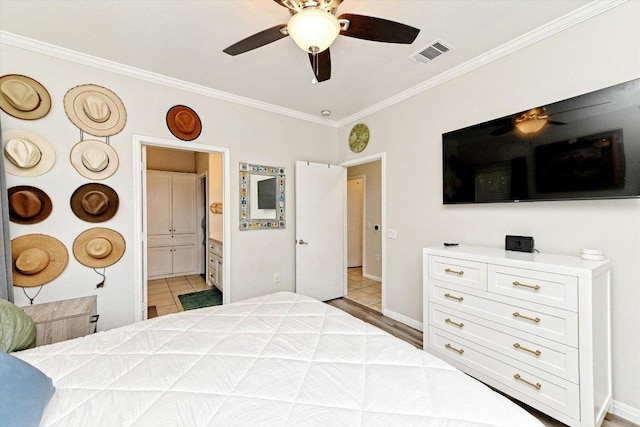 7312 Meador Ave, Austin, TX 78752 - bedroom featuring crown molding, tile patterned floors, ensuite bathroom, and ceiling fan