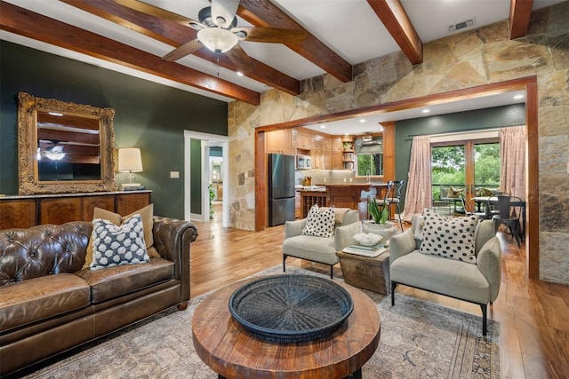 79 Saddle Rock Rdg, Wimberley, TX 78676 - living area featuring light wood finished floors, beamed ceiling, and a ceiling fan