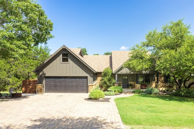 79 Saddle Rock Rdg, Wimberley, TX 78676 - view of front of property featuring a front lawn, covered porch, decorative driveway, a garage, and board and batten siding