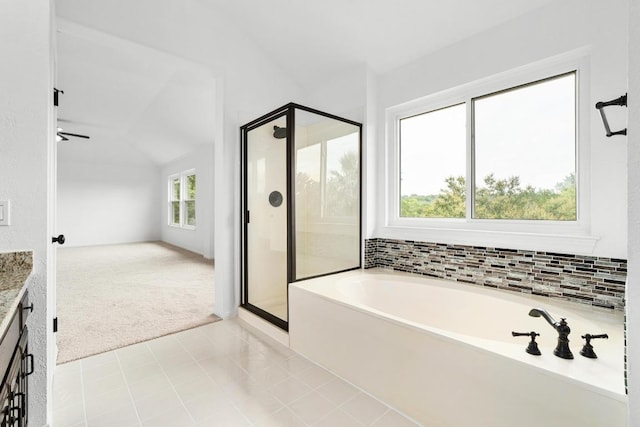 10504 Grand Oak Cir, Austin, TX 78750 - bathroom featuring a shower stall, a bath, lofted ceiling, and vanity