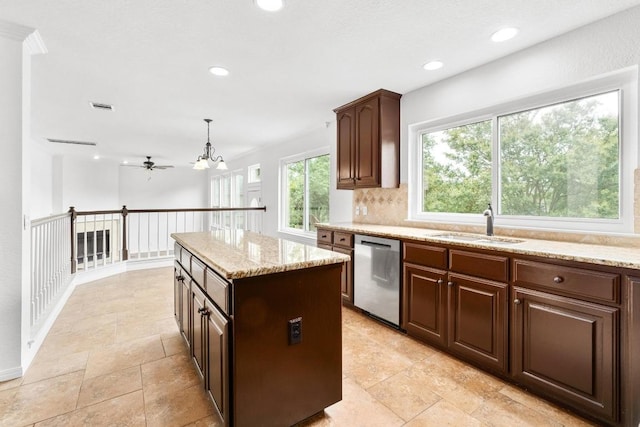 10504 Grand Oak Cir, Austin, TX 78750 - kitchen featuring stainless steel dishwasher, a ceiling fan, light stone countertops, a center island, and recessed lighting