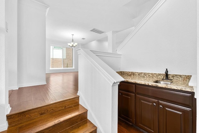 10504 Grand Oak Cir, Austin, TX 78750 - staircase with a chandelier and hardwood / wood-style flooring