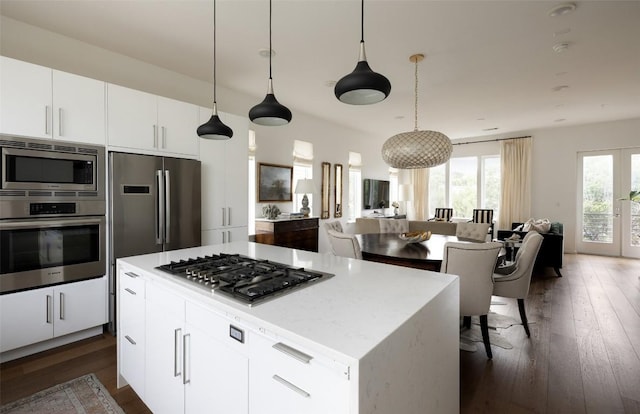 3100 Menchaca Rd Unit 10, Austin, TX 78704 - kitchen featuring stainless steel appliances, open floor plan, dark wood-type flooring, and white cabinetry