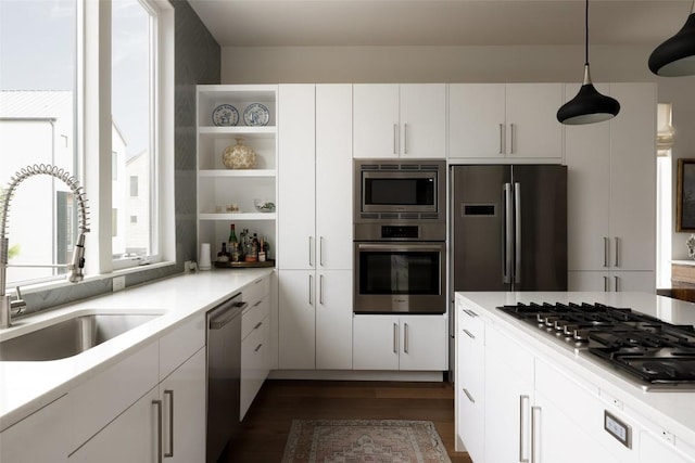 3100 Menchaca Rd Unit 10, Austin, TX 78704 - kitchen with appliances with stainless steel finishes, open shelves, dark wood finished floors, white cabinetry, and light countertops