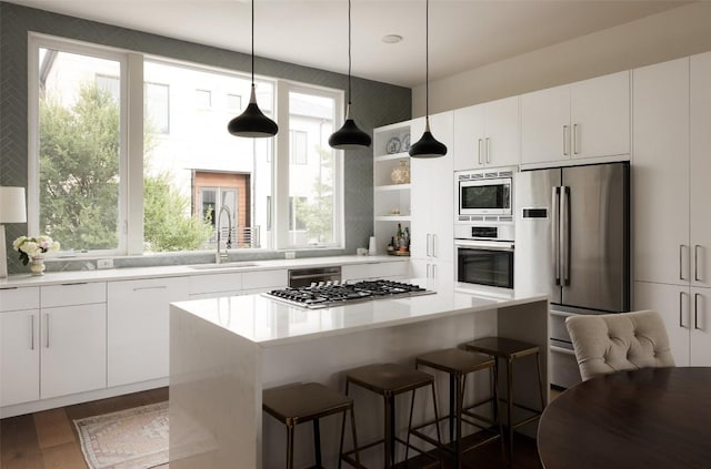 3100 Menchaca Rd Unit 10, Austin, TX 78704 - kitchen featuring stainless steel appliances, open shelves, a kitchen island, and white cabinets
