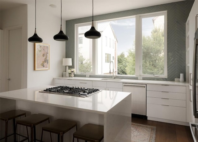 3100 Menchaca Rd Unit 10, Austin, TX 78704 - kitchen with appliances with stainless steel finishes, white cabinets, a center island, dark wood-style floors, and modern cabinets