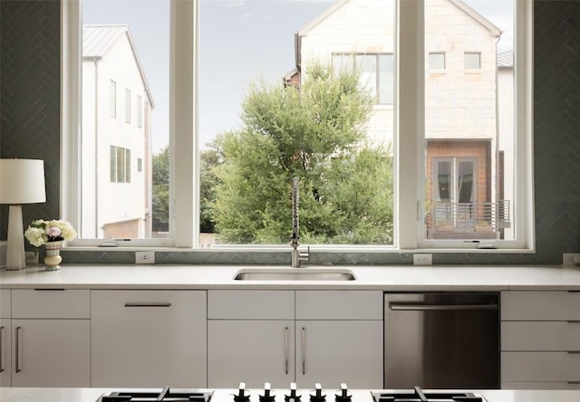 3100 Menchaca Rd Unit 10, Austin, TX 78704 - kitchen with dishwasher, light countertops, white cabinetry, and decorative backsplash