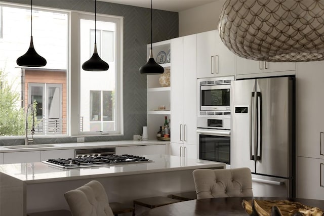 3100 Menchaca Rd Unit 10, Austin, TX 78704 - kitchen featuring appliances with stainless steel finishes, open shelves, a breakfast bar area, and light countertops