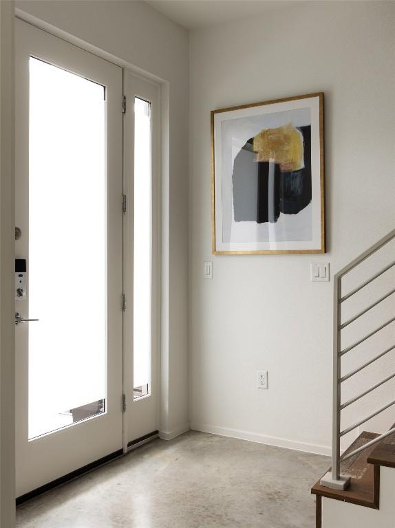 3100 Menchaca Rd Unit 10, Austin, TX 78704 - entryway featuring stairway, healthy amount of natural light, and concrete flooring