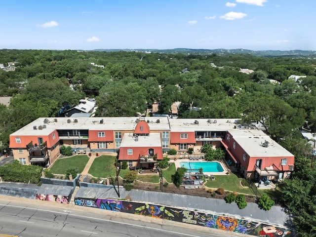900 S Lamar Blvd Unit 304, Austin, TX 78704 - drone / aerial view of a pool area and a heavily wooded area