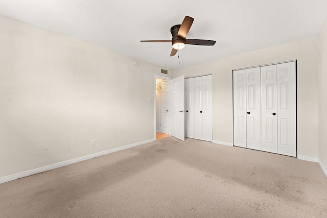 900 S Lamar Blvd Unit 304, Austin, TX 78704 - unfurnished bedroom featuring light colored carpet, two closets, and ceiling fan