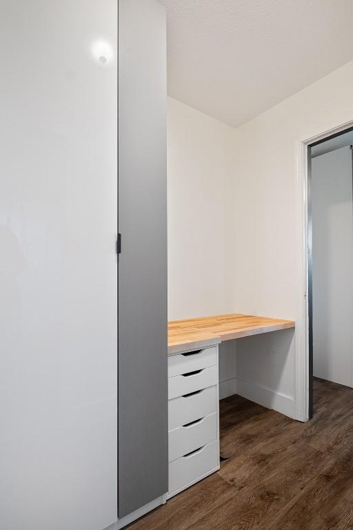 13516 Caldwell Dr, Austin, TX 78750 - unfurnished office featuring dark wood-style flooring and built in study area