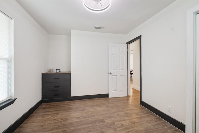 13516 Caldwell Dr, Austin, TX 78750 - unfurnished bedroom with wood finished floors and baseboards