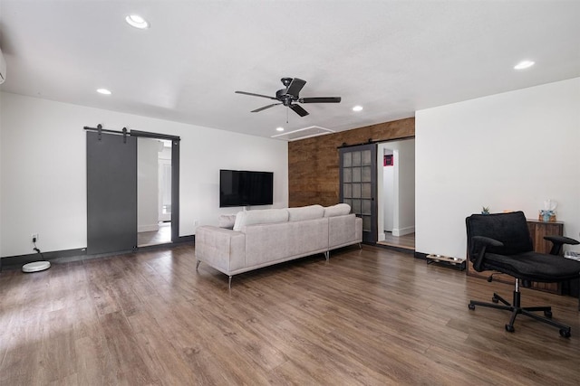 13516 Caldwell Dr, Austin, TX 78750 - living area featuring a barn door, wood finished floors, ceiling fan, and recessed lighting
