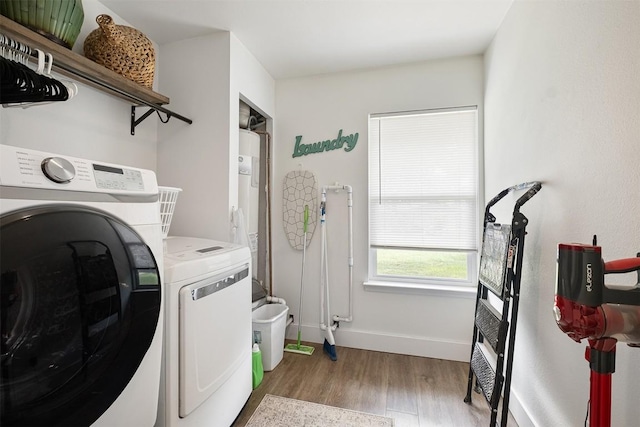 13516 Caldwell Dr, Austin, TX 78750 - washroom with washer and clothes dryer and wood finished floors