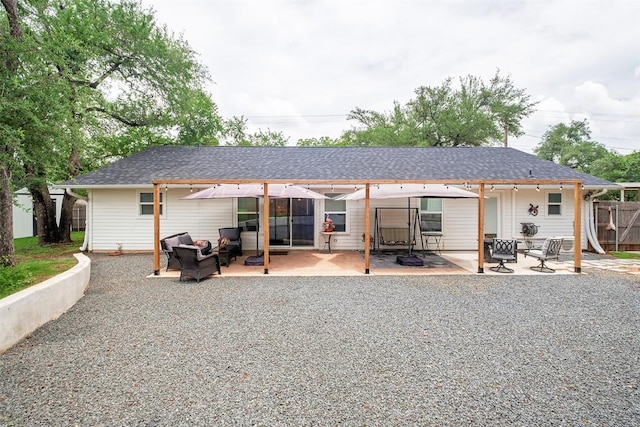 13516 Caldwell Dr, Austin, TX 78750 - rear view of house with a patio area, outdoor lounge area, and roof with shingles