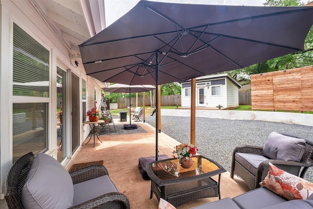 13516 Caldwell Dr, Austin, TX 78750 - fenced backyard featuring an outdoor living space, an outbuilding, and a patio area
