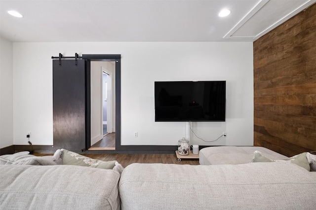 13516 Caldwell Dr, Austin, TX 78750 - living room featuring wood finished floors, a barn door, recessed lighting, and wooden walls