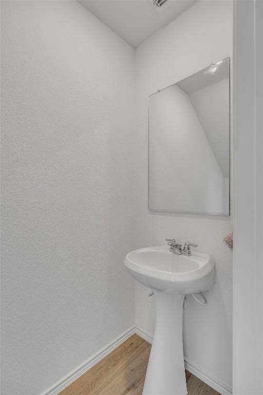 2406 Windrow Ln, Lockhart, TX 78644 - bathroom with wood finished floors and baseboards