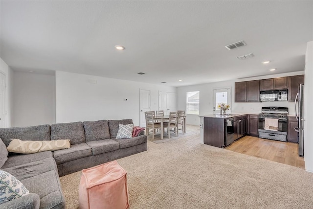 2406 Windrow Ln, Lockhart, TX 78644 - living room featuring light colored carpet and recessed lighting