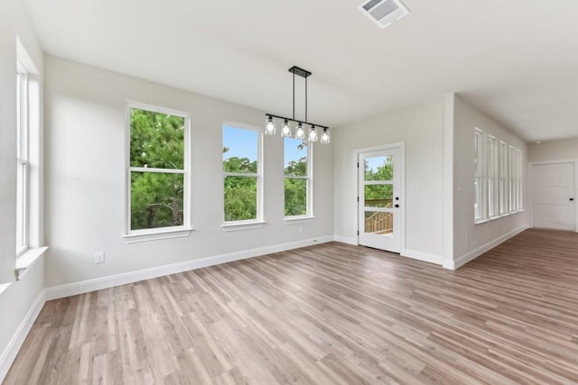 130 Mokalau Dr, Bastrop, TX 78602 - unfurnished dining area with light wood finished floors and a chandelier