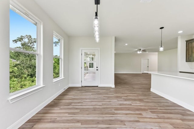 130 Mokalau Dr, Bastrop, TX 78602 - unfurnished living room with plenty of natural light, light wood-style flooring, recessed lighting, and a ceiling fan