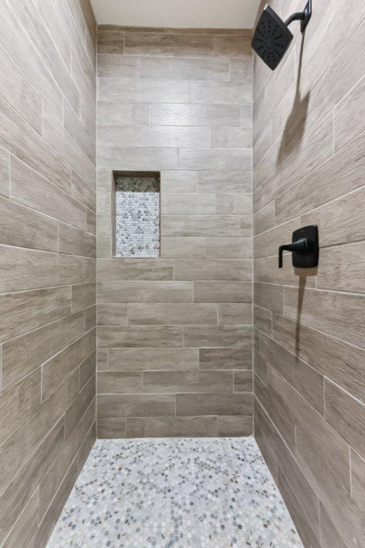 130 Mokalau Dr, Bastrop, TX 78602 - full bathroom with tiled shower