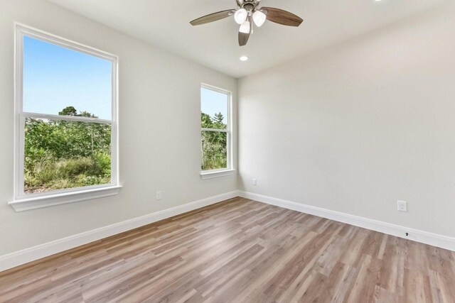 130 Mokalau Dr, Bastrop, TX 78602 - empty room with light wood-style floors, ceiling fan, and recessed lighting