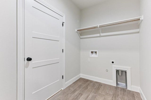 130 Mokalau Dr, Bastrop, TX 78602 - laundry room with electric dryer hookup, hookup for a gas dryer, washer hookup, and light wood-style floors