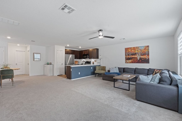 17704 Oso Cv, Elgin, TX 78621 - living area featuring a ceiling fan, light colored carpet, and recessed lighting