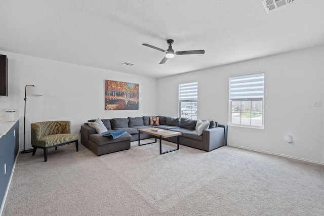 17704 Oso Cv, Elgin, TX 78621 - living room featuring a ceiling fan, light carpet, and a textured ceiling