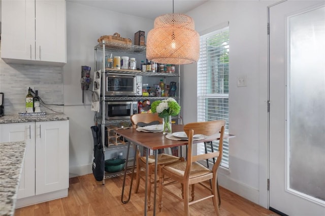 5820 Berkman Dr Unit 205, Austin, TX 78723 - dining area with light wood-type flooring and baseboards