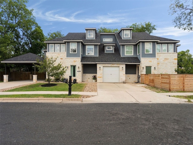 5408 Prock Ln Unit A, Austin, TX 78721 - view of front of home featuring stone siding, driveway, an attached garage, and roof with shingles