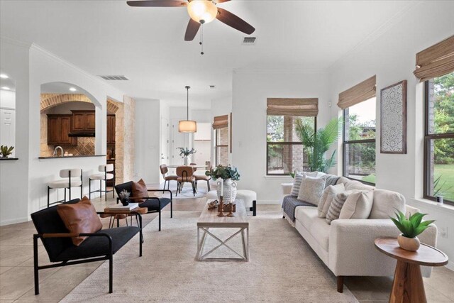 211 Longmont Ln, Austin, TX 78737 - living room with ceiling fan, light tile patterned floors, and ornamental molding