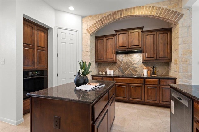 211 Longmont Ln, Austin, TX 78737 - kitchen featuring black appliances, light tile patterned floors, decorative backsplash, under cabinet range hood, and dark stone counters