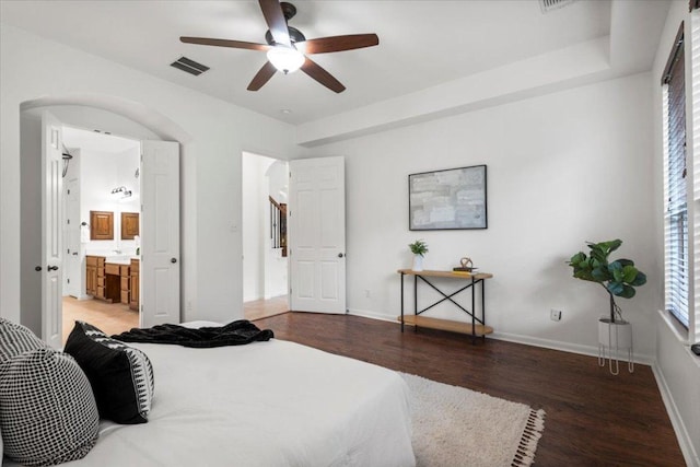 211 Longmont Ln, Austin, TX 78737 - bedroom with wood finished floors, arched walkways, connected bathroom, and a ceiling fan