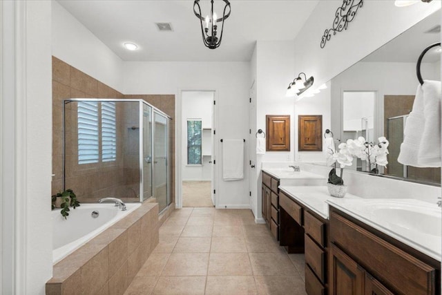 211 Longmont Ln, Austin, TX 78737 - full bathroom featuring double vanity, a stall shower, a bath, and tile patterned floors