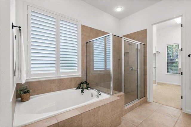 211 Longmont Ln, Austin, TX 78737 - full bathroom with a bath, a stall shower, tile patterned floors, and healthy amount of natural light