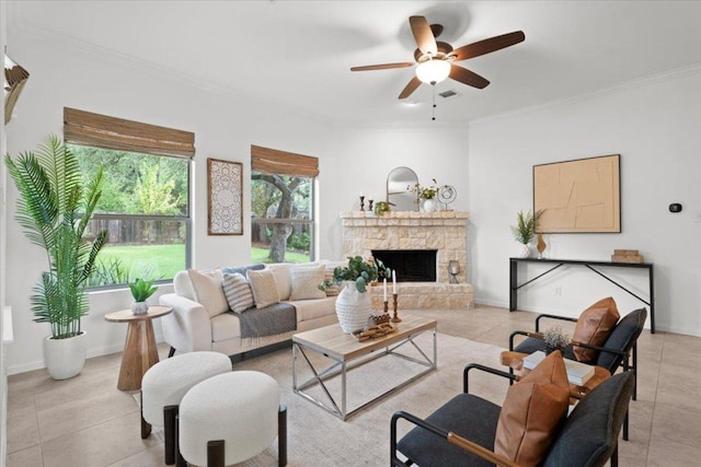 211 Longmont Ln, Austin, TX 78737 - living room with crown molding, ceiling fan, a stone fireplace, and light tile patterned floors