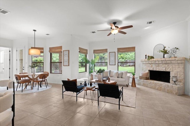 211 Longmont Ln, Austin, TX 78737 - living room with a fireplace, light tile patterned floors, a ceiling fan, and crown molding