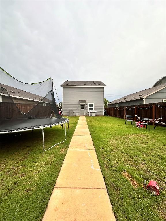 1214 Smallmouth Rd, Bastrop, TX 78602 - view of yard with a trampoline