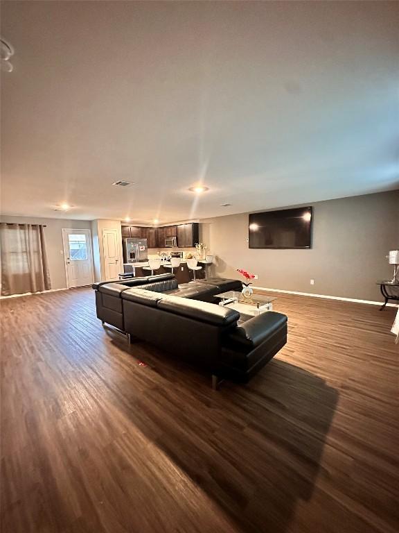 1214 Smallmouth Rd, Bastrop, TX 78602 - living area featuring dark wood-type flooring and baseboards